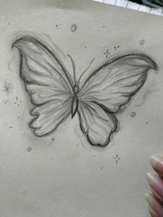 a pencil drawing of a butterfly on paper