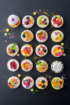 cupcakes decorated with fresh fruit are arranged in the shape of an e - sign