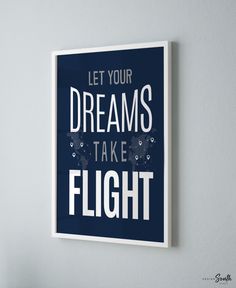 a poster hanging on the wall that says let your dreams take flight