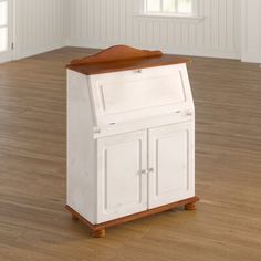 a small white cabinet sitting on top of a hard wood floor