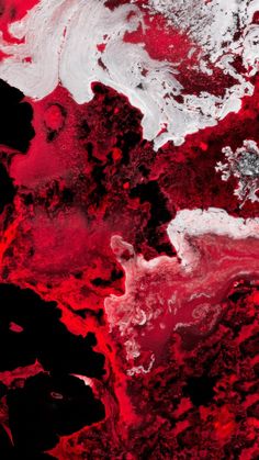 an abstract red and white painting with lots of black paint on it's surface