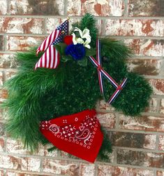 an american flag wreath on a brick wall