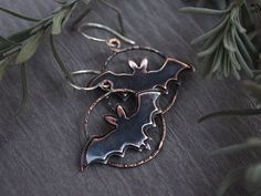 These minimalistic bat earrings were made out of copper sheet, wire and silver wire (ear hooks). It can be perfect gift for person, who loves bats or feels the Halloween everyday. It is part of story about real witch. About Bat queen. Earring is approximately  1  x 1 3/8 in The ear wire is made of sterling silver wire. Every earring is *slightly* different because of handmade. The colours may be slightly different because of monitor. You can see other earrings here: https://www.etsy.com/shop/AnnTitovaDesign?section_id=26651169 You can find my jewelry news here: https://www.facebook.com/AnnTitovaDesign/ https://www.instagram.com/AnnTitovaDesign/ If you have any questions, please, write me =) Magic Earrings, Wire Wrap Jewelry Designs, Phoenix Pendant, Bat Earrings, Halloween Everyday, Witch Magic, Copper Sheets, On The Moon, Wedding Jewelry Earrings