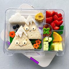 a bento box filled with fruit and veggies to look like the shape of a triangle