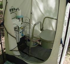 a white toilet sitting inside of a tent