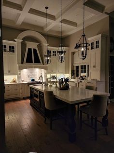 a large kitchen with an island in the middle