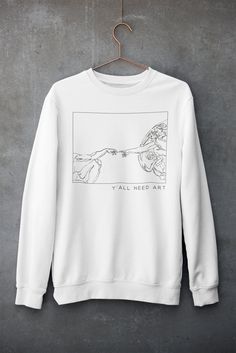 "You will love this classic crew neck sweatshirt featuring a line art version of Michelangelo's masterpiece: Creation of Adam with \"Y'ALL NEED ART\" slogan! Oversized aesthetic sweats are so hot right now so order a size up and style it with faux leather leggings and combat boots or sneakers. It's the perfect choice for cooler evenings, festivals or just for cozying up on the sofa. ------------------------------------------------------------------------------------------------------------------ Adam Aesthetic, Art Slogans, Leggings And Combat Boots, Nirvana Sweatshirt, Oversized Aesthetic, Art Sweatshirt, Mom Sweater, Aesthetic Tumblr, Aesthetic Clothing