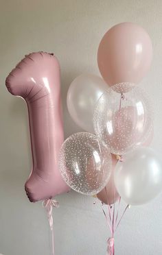 some balloons are in the shape of an ice cream cone and one balloon is pink