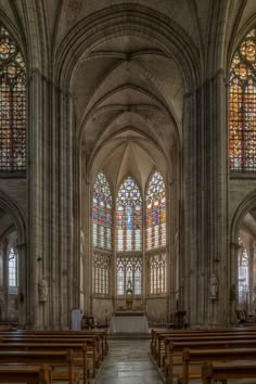 an old church with stained glass windows and pews