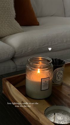 a candle sitting on top of a wooden tray