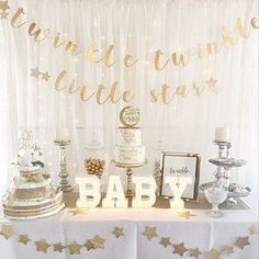 a table topped with cake and desserts on top of it's tables covered in white and gold confetti