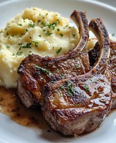 some meat and mashed potatoes on a white plate