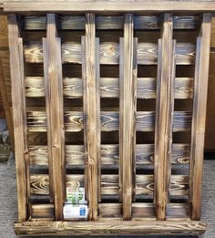 an old wooden crate with wood slats on the sides and some paint in it