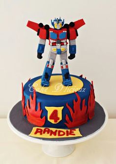 a birthday cake with a transformer figure on top