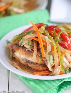 a white plate topped with chicken and vegetables