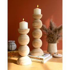 a stack of wooden candles sitting on top of a table