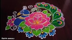 an artistically decorated peacock and flower design on a table