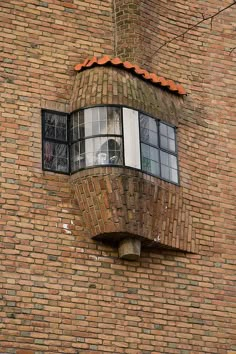 a brick building with a round window on the side