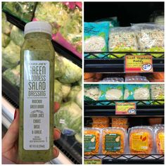 a person holding up a bottle of salad dressing in front of the produce section of a grocery store