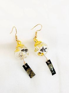 the earrings are made from glass and gold