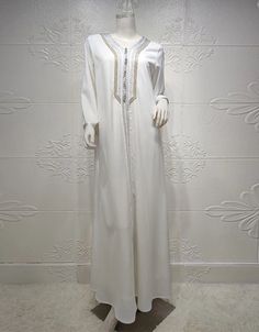 SPECIFICATIONS Elevate your style with our Polyester Abaya adorned with intricate embroidery. Perfect for various occasions, this piece combines comfort and sophistication effortlessly. Order now to embrace a timeless and fashionable look. Processing Time : 20-25 Business Days Department Name: Adult. Material: High-quality Polyester for comfort and durability. Decoration: Exquisite Embroidery, adding a touch of elegance. Item Type: Abaya, a versatile and stylish addition to your wardrobe. Elegant Long Sleeve Kaftan For Eid, Elegant White Long Sleeve Agbada, Elegant Embroidered Floor-length Abaya, Elegant White Long Sleeve Abaya, White Floor-length Abaya, Elegant Long Sleeve Thobe With Dabka Embroidery, White Floor-length Abaya For Eid, Elegant Long Sleeve Thobe With Dabka, Traditional White Embellished Kaftan