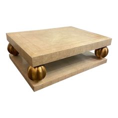 a coffee table with two golden balls on it's legs and a white background