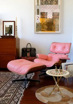 a pink chair and ottoman in a living room