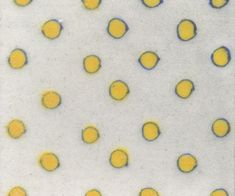 yellow and blue dots are arranged on a white surface