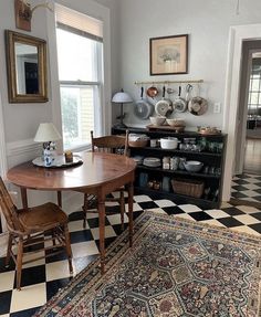 a table and chairs in a room with black and white checkered flooring