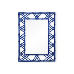 a mirror that is sitting on top of a table next to a white wall with a black frame