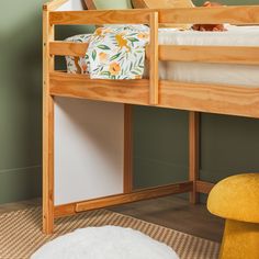 a wooden bunk bed sitting on top of a hard wood floor next to a white rug