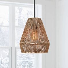 a light hanging from a ceiling in front of a window with white walls and windowsill