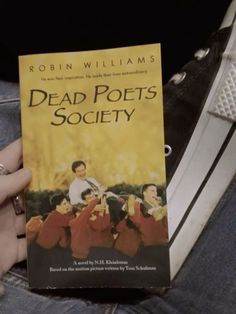 a person holding up a book in their hand with the title dead pots society written on it