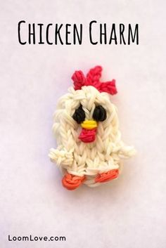 a chicken brooch sitting on top of a white surface with the words chicken charm written above it