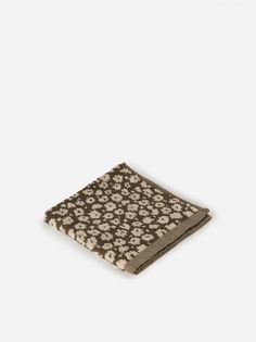 a brown and white flower patterned napkin