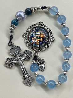 Pocket Rosary blue rosary Holy Family Centerpiece Christmas Rosary, Catholic woman, Catholic gift, Catholic mom gift, handmade rosary    Catholic gift, Catholic mom, Catholic gift, catholic gift for her, Catholic mom, RCIA, Confirmation gift, weddings These one of a kind handmade rosaries are beautiful and would make a wonderful Reconciliation or Confirmation gift! Also great for wedding gift or RCIA gift! The colors are gorgeous!  The antique bronze crucifix and Medal are beautifully detailed. Spiritual Beaded Rosary As Gift, Turquoise Rosary Bracelet With Round Beads As Gift, Blue Beaded Rosary As A Gift, Handmade Turquoise Rosary Bracelet As Gift, Adjustable Spiritual Rosary As Gift, Spiritual Blue Jewelry For Mother's Day, Adjustable Rosary With Miraculous Medal Gift, Blue Rosary Bracelet For Jewelry Making, Handmade Blue Rosary For Jewelry Making