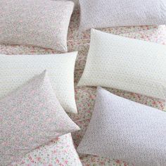 several pillows are arranged on top of each other in the same pattern as they appear to be made out of fabric