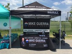 a tent set up in the middle of a park with an advertisement for mike guera