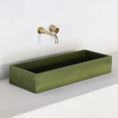 a green soap dish sitting on top of a white counter