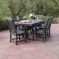 an outdoor dining table with six chairs around it