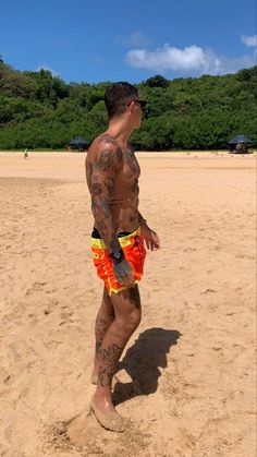 a man standing on top of a sandy beach