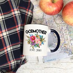 a plaid blanket and two apples on top of a map