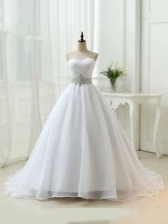 a white wedding dress on a mannequin