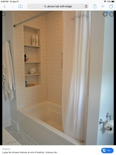 a bathroom with white tile walls and flooring, including a bathtub next to a shower curtain