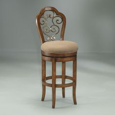 a wooden bar stool with a beige upholstered seat and back cushion on an isolated grey background