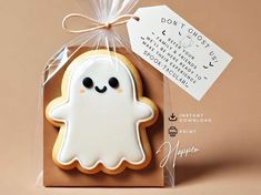 a cookie shaped like a ghost with a tag attached to it's front and back