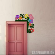 an open pink door with flowers on the top and bottom, in front of a white wall