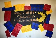 a bulletin board with legos on it that says building a strong foundation to short, for the moon