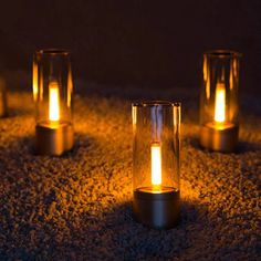 five lit candles sitting on top of a carpet