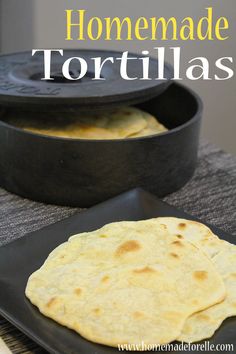 homemade tortillas on a black plate next to a cast iron skillet with text overlay